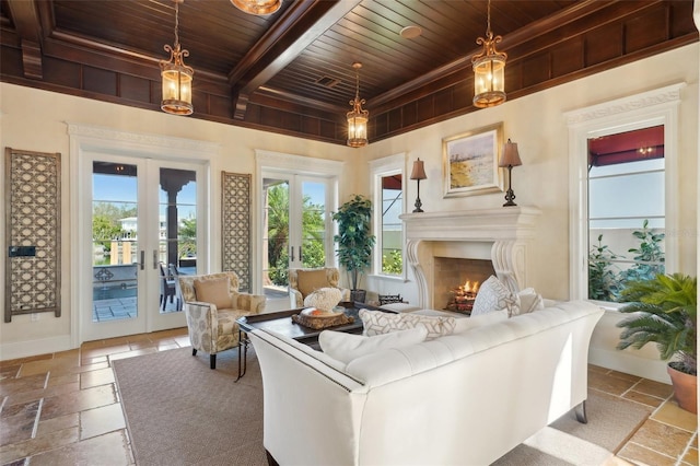 sitting room featuring wood ceiling, a healthy amount of sunlight, baseboards, french doors, and stone tile flooring