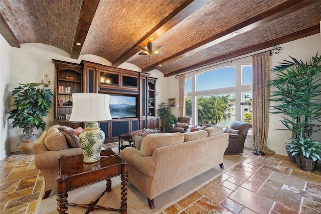 living area with brick ceiling, stone tile flooring, and baseboards