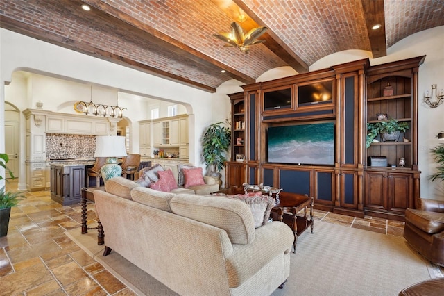 living area featuring brick ceiling, stone tile flooring, and arched walkways