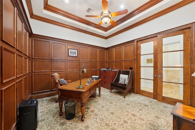 office featuring ceiling fan, a decorative wall, visible vents, french doors, and crown molding