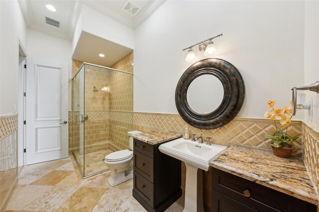 bathroom featuring a wainscoted wall, tile walls, visible vents, toilet, and a stall shower