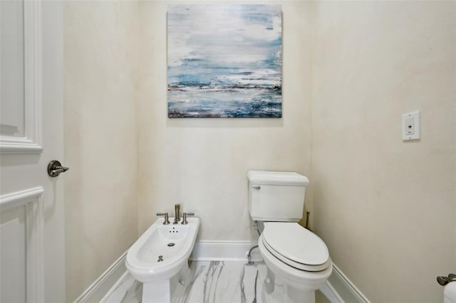 half bathroom with marble finish floor, a bidet, toilet, and baseboards