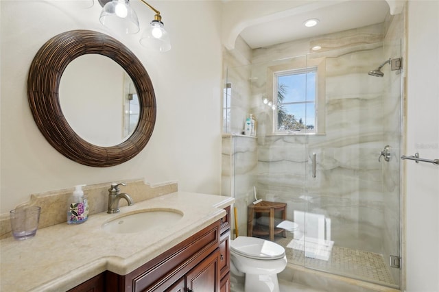 bathroom featuring a stall shower, vanity, and toilet