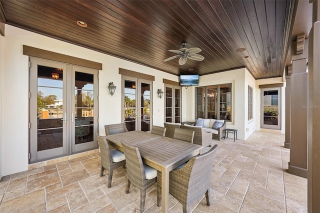 view of patio featuring a ceiling fan, outdoor dining space, and french doors