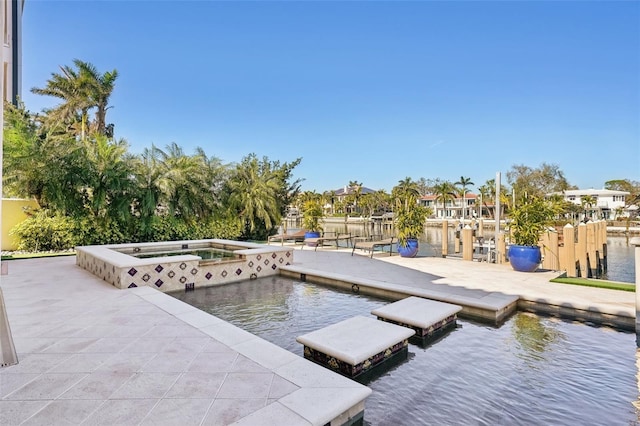 dock area featuring a water view and an in ground hot tub