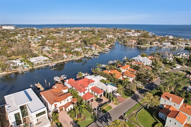 drone / aerial view with a water view and a residential view