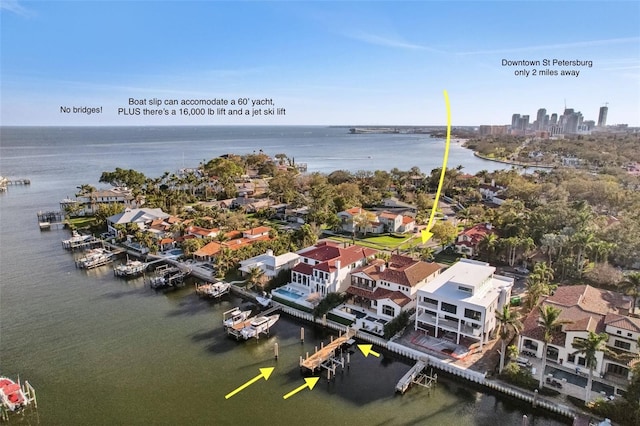 birds eye view of property featuring a water view and a city view