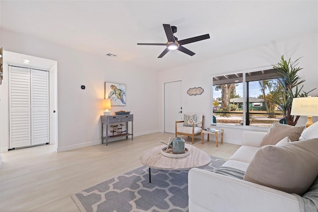 living room with ceiling fan and light wood-type flooring