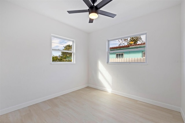 spare room featuring light hardwood / wood-style flooring and ceiling fan