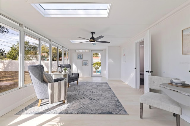 sunroom with ceiling fan and a skylight