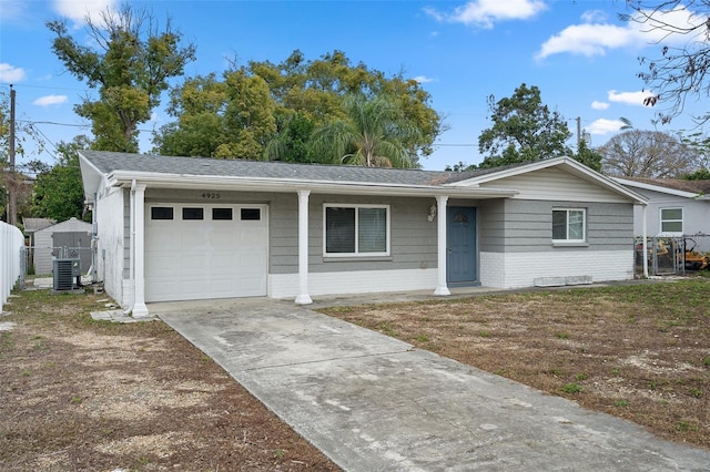 ranch-style house with a garage and central AC