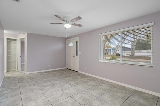 spare room with light tile patterned flooring and ceiling fan