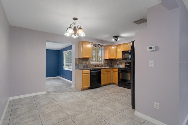 kitchen featuring pendant lighting, light brown cabinetry, sink, decorative backsplash, and black appliances