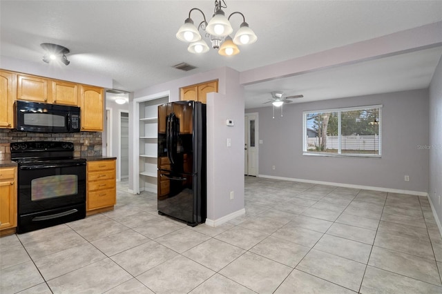 kitchen with tasteful backsplash, hanging light fixtures, light tile patterned floors, black appliances, and a textured ceiling