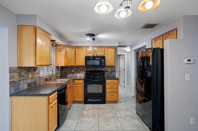 kitchen featuring sink, light tile patterned floors, tasteful backsplash, black appliances, and a textured ceiling