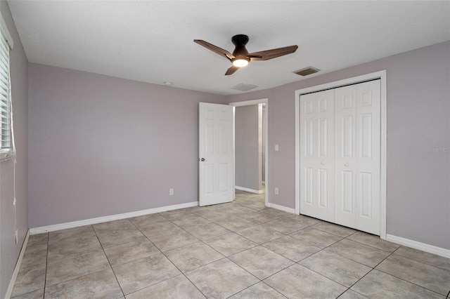 unfurnished bedroom featuring light tile patterned flooring, ceiling fan, and a closet