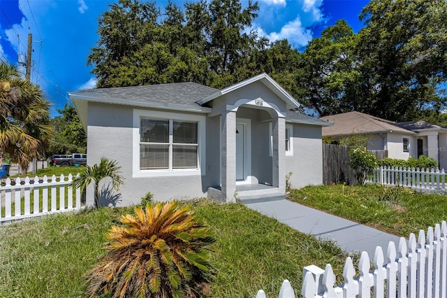 bungalow-style house featuring a front yard