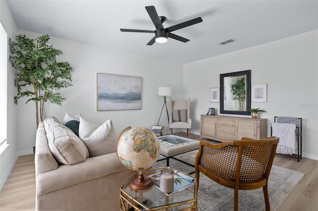 living room with light hardwood / wood-style floors and ceiling fan