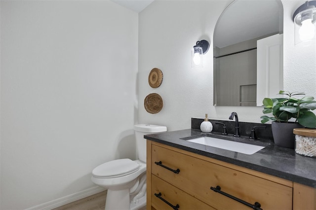 bathroom with vanity, hardwood / wood-style flooring, and toilet