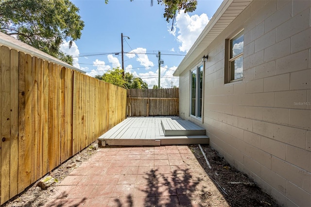 wooden terrace featuring a patio area