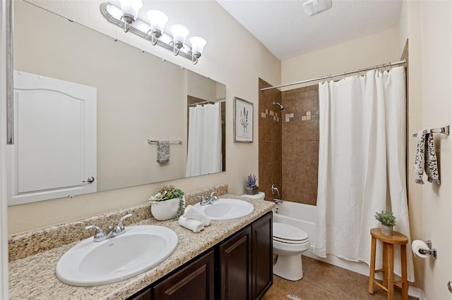 full bathroom featuring vanity, shower / bath combination with curtain, a textured ceiling, tile patterned floors, and toilet