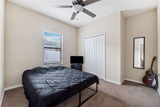 bedroom featuring light colored carpet, a closet, and ceiling fan