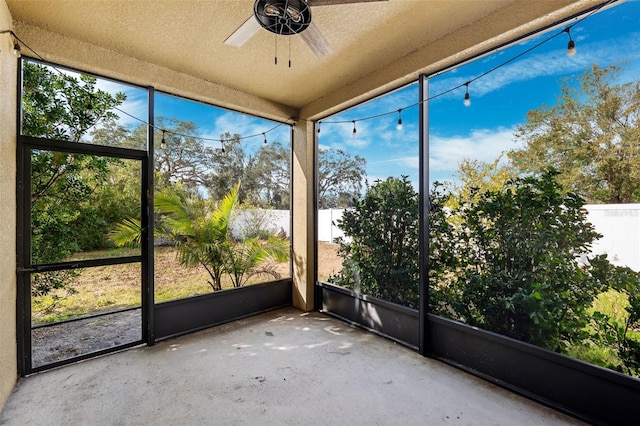 unfurnished sunroom featuring ceiling fan