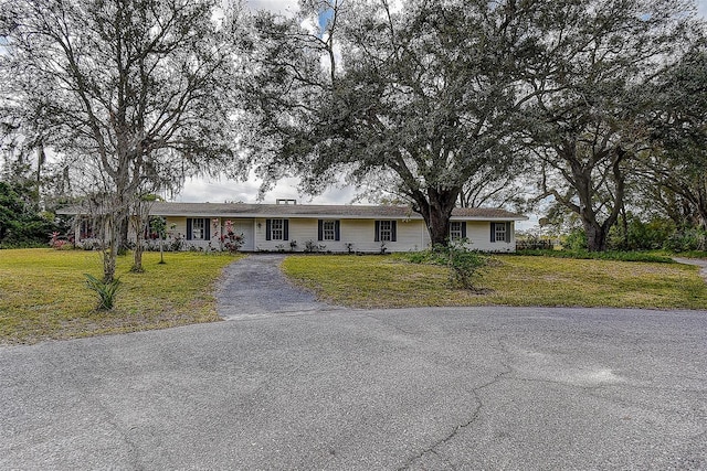 ranch-style home featuring a front yard