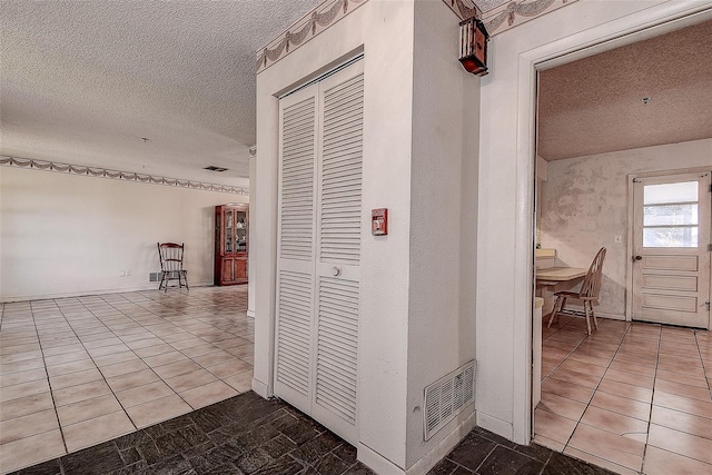 hallway with a textured ceiling