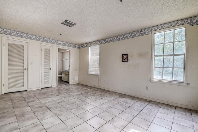 unfurnished bedroom featuring a textured ceiling