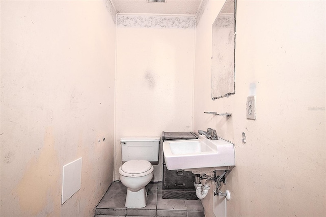 bathroom featuring tile patterned flooring, sink, and toilet