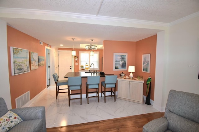 dining room featuring sink and a textured ceiling