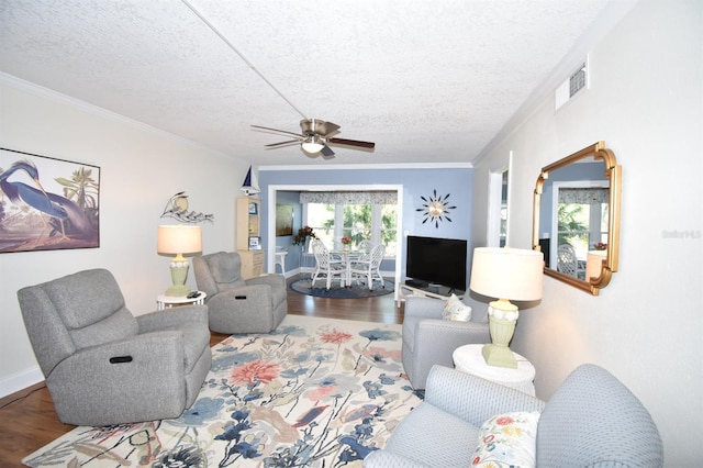 living room featuring ornamental molding, hardwood / wood-style floors, and a textured ceiling