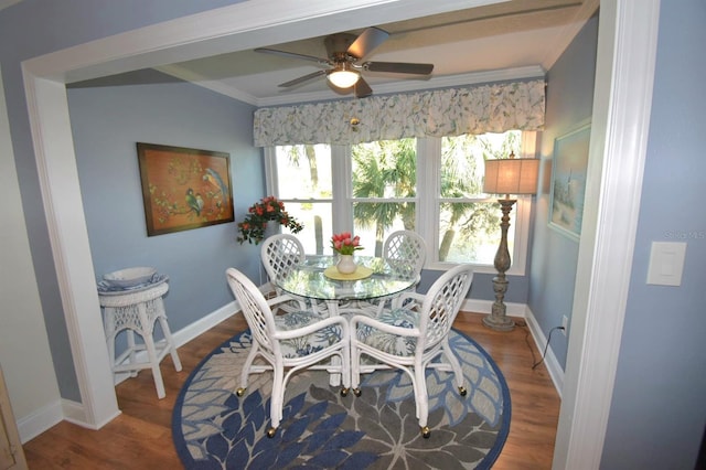 dining room with wood-type flooring, ornamental molding, and ceiling fan