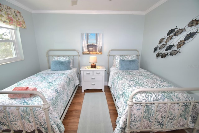 bedroom featuring crown molding and dark hardwood / wood-style flooring