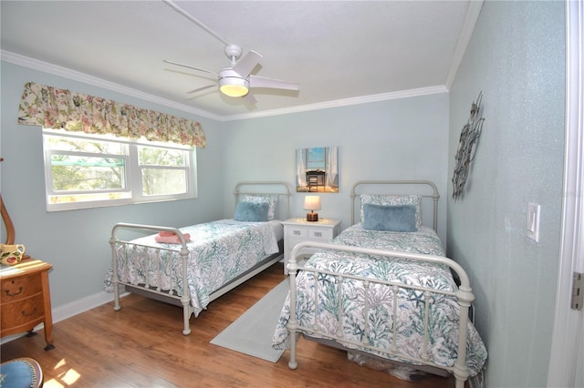 bedroom featuring ornamental molding, hardwood / wood-style floors, and ceiling fan