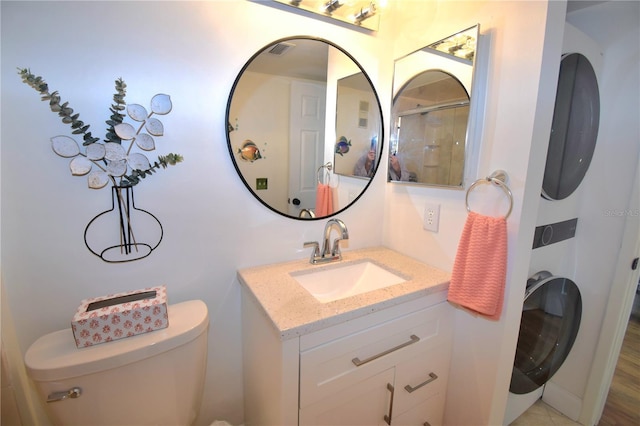 bathroom with vanity, a shower, and toilet