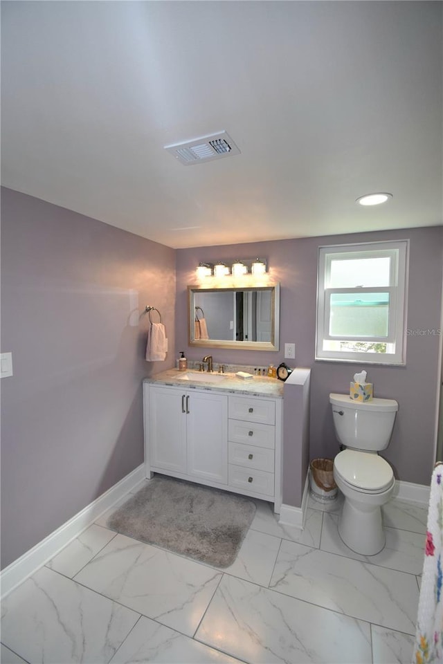 bathroom featuring vanity and toilet