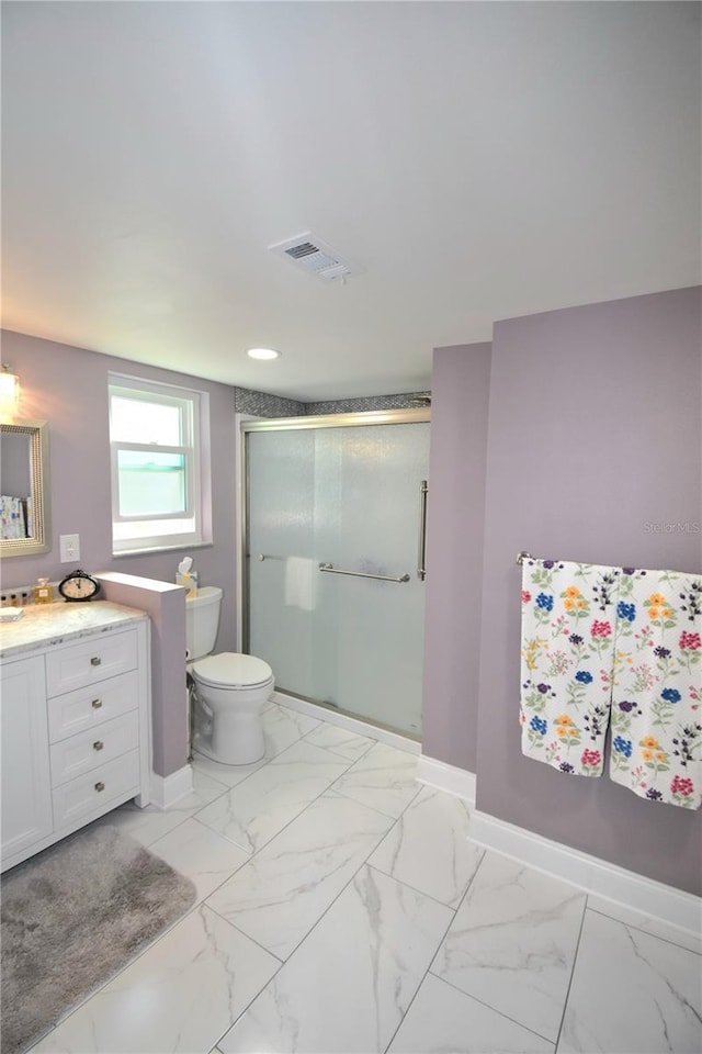 bathroom with vanity, toilet, and an enclosed shower