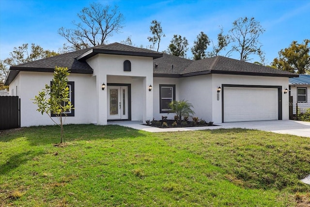 view of front of house featuring a garage and a front lawn