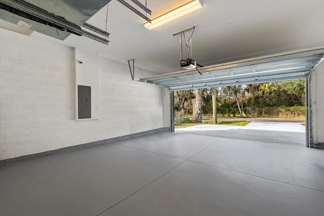 garage with a garage door opener and electric panel