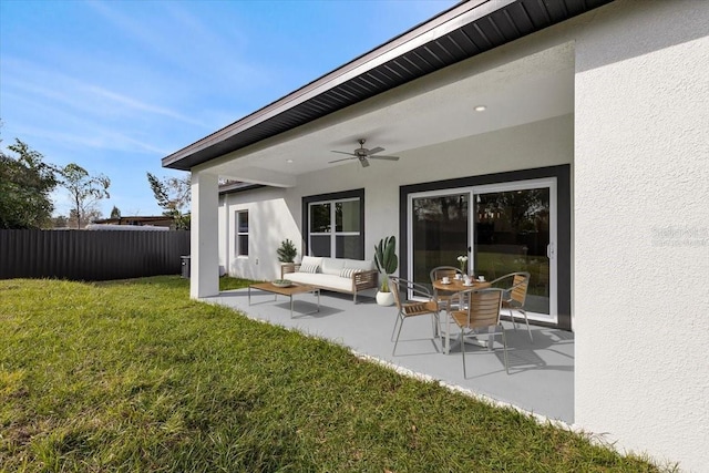 back of property featuring ceiling fan, a yard, an outdoor hangout area, and a patio area