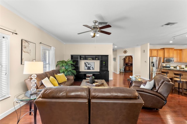 living room with ornamental molding, dark hardwood / wood-style floors, and ceiling fan