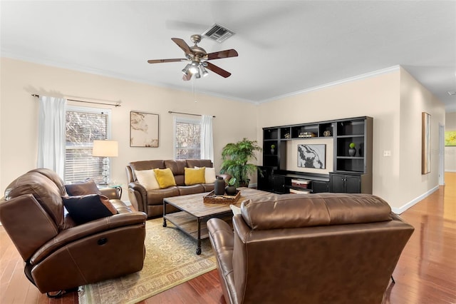 living room with crown molding, light hardwood / wood-style flooring, and ceiling fan