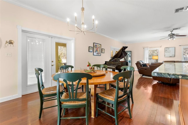 dining space with french doors, crown molding, and dark wood-type flooring