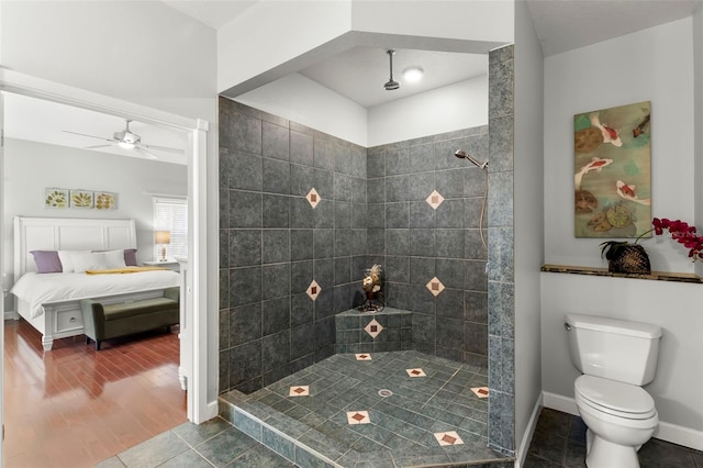 bathroom with ceiling fan, toilet, tile patterned flooring, and a tile shower