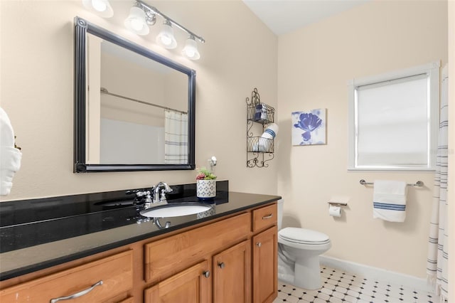 bathroom with vanity, a shower with shower curtain, and toilet