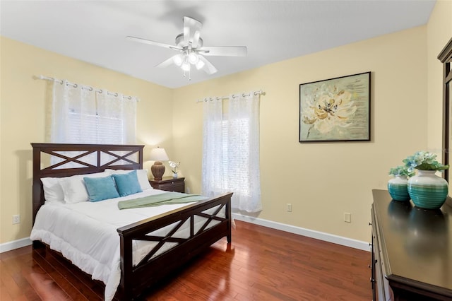 bedroom with ceiling fan and dark hardwood / wood-style floors