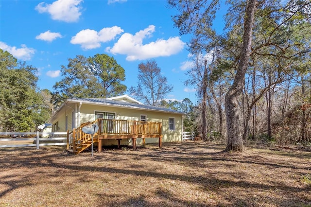 back of house with a wooden deck