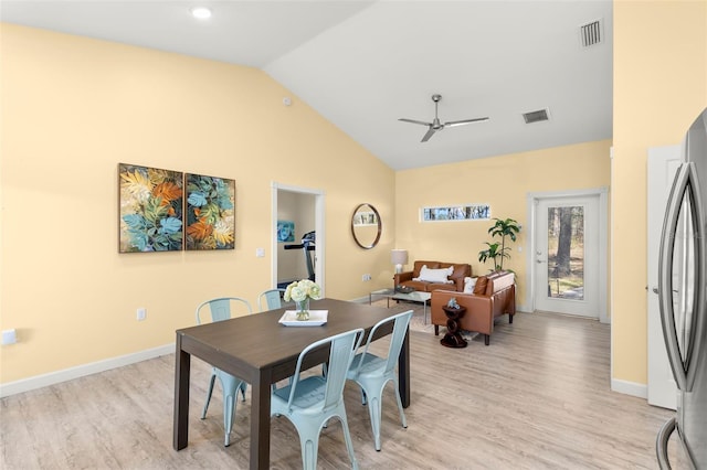 dining space featuring ceiling fan, high vaulted ceiling, and light hardwood / wood-style floors